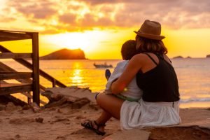 mother with her son at sunset in cala comte beach 2023 11 27 05 26 50 utc min